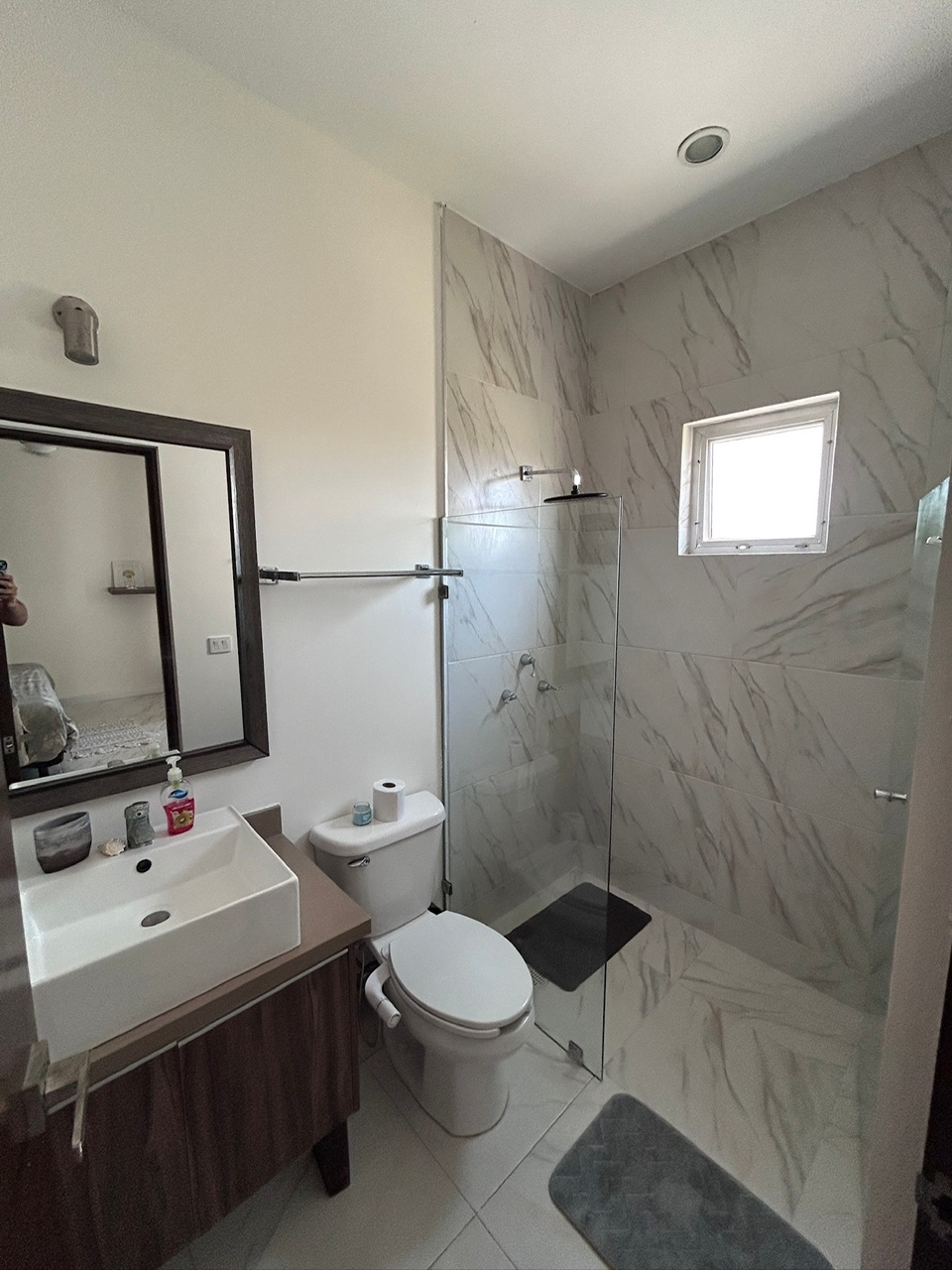 Modern marble en-suite bathroom with walk-in shower