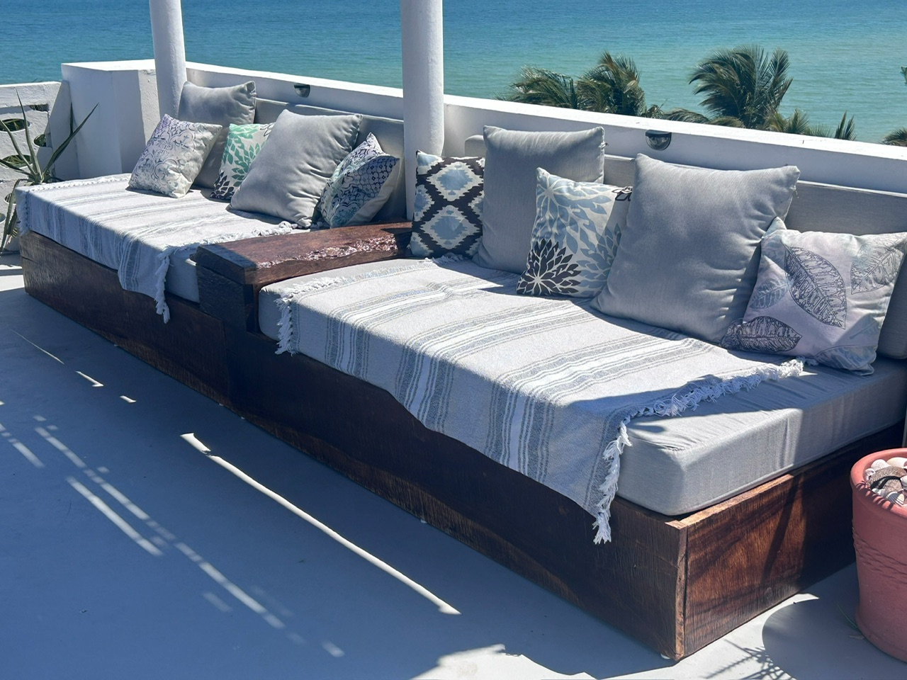 Long rooftop daybed facing the turquoise sea
