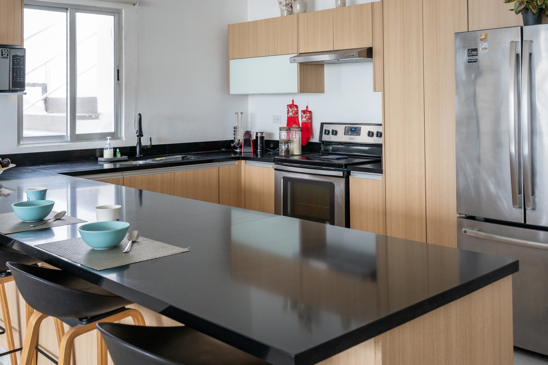 Full kitchen with breakfast bar and stainless steel appliances